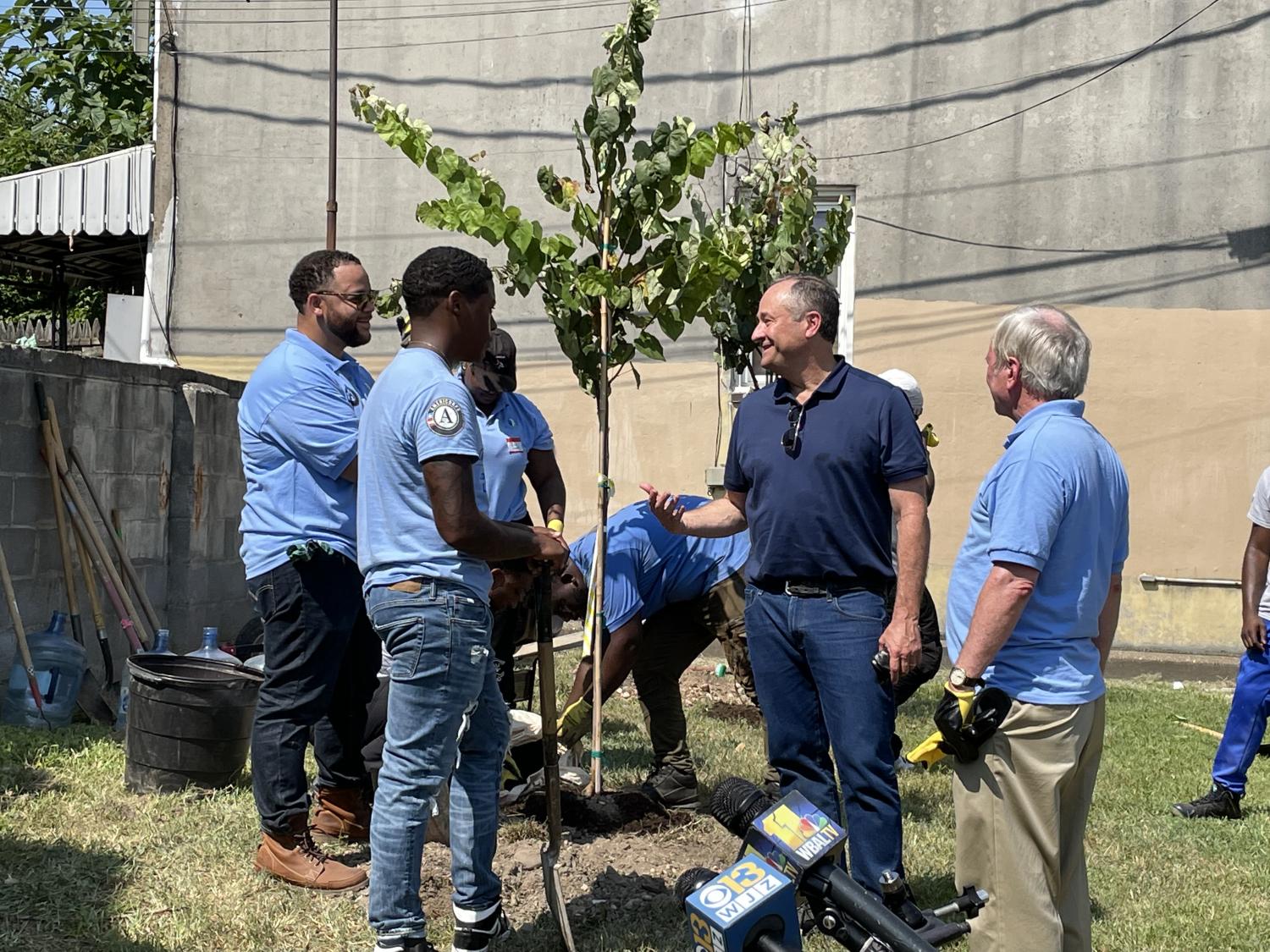 Second Gentleman, AmeriCorps CEO and Baltimore Mayor plant trees with AmeriCorps members.