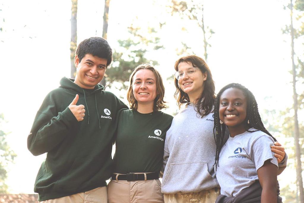 AmeriCorps members pose and smile.