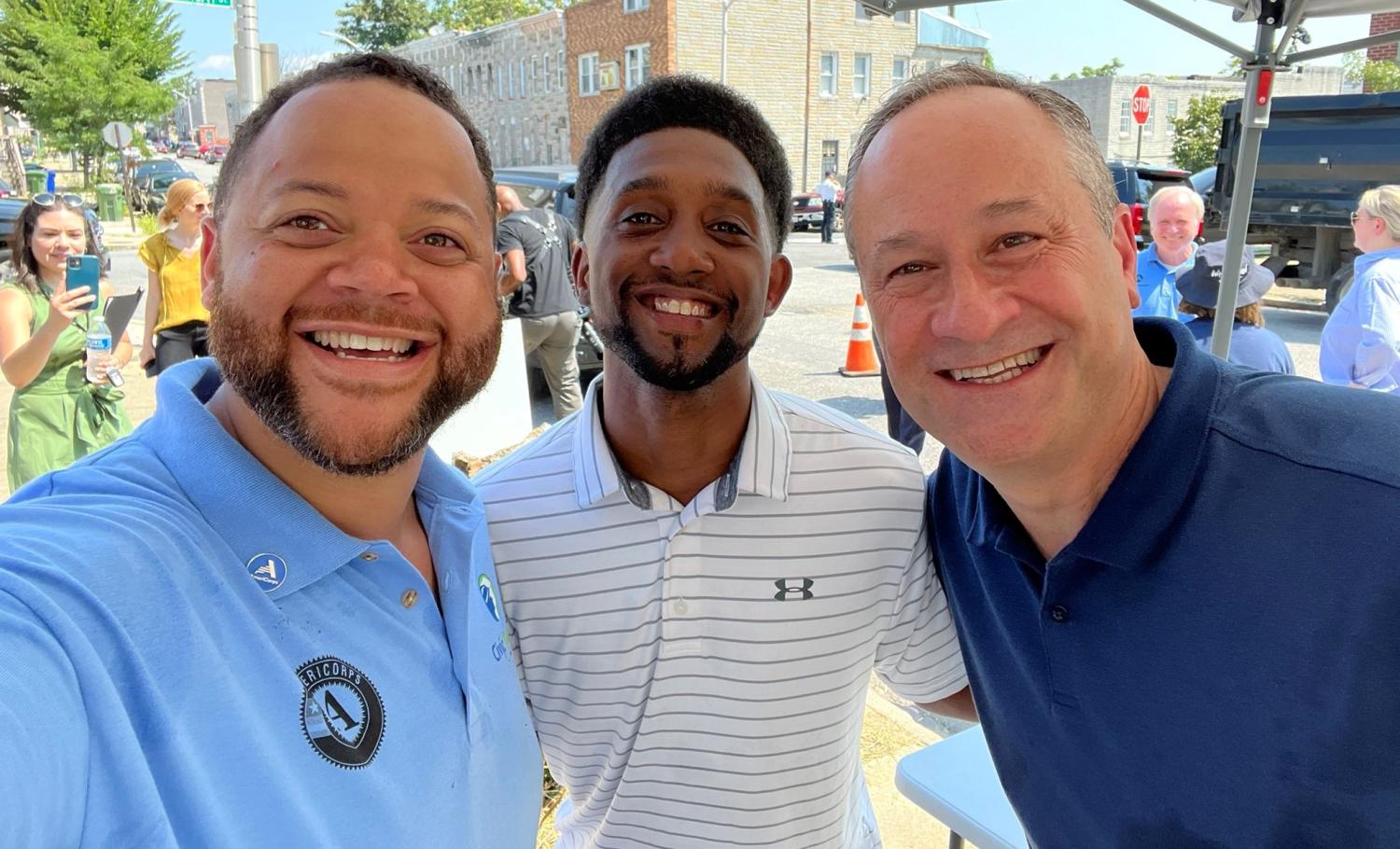 AmeriCorps CEO Michael D. Smith, Second Gentleman Douglas Emhoff, and Baltimore Mayor Brandon Scott pose for a 'selfie' during their service project with City Works in Baltimore.