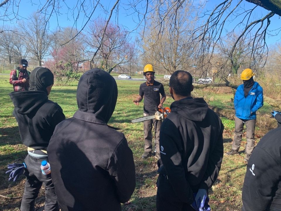 Jaiden and team teaching about chainsaw use to to a new crew