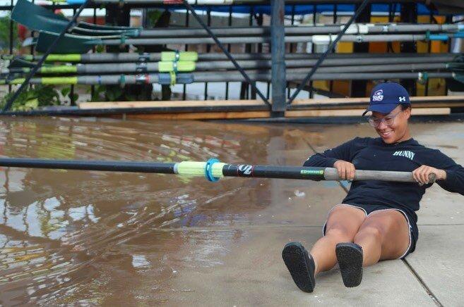 Amilia holding a rowing oar. 