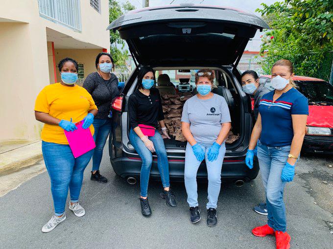 AmeriCorps members by van with supplies