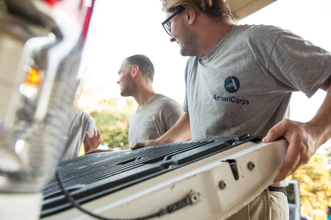 AmeriCorps members loading a truck