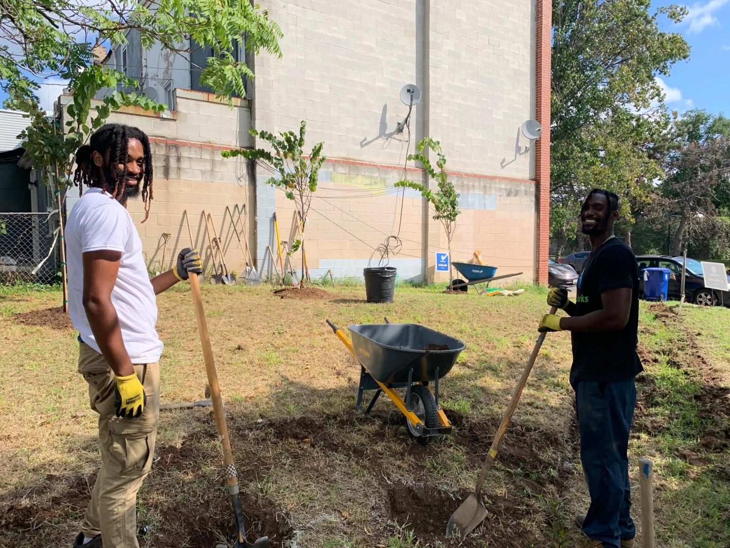 AmeriCorps members and volunteers beatify an vacant lot. 