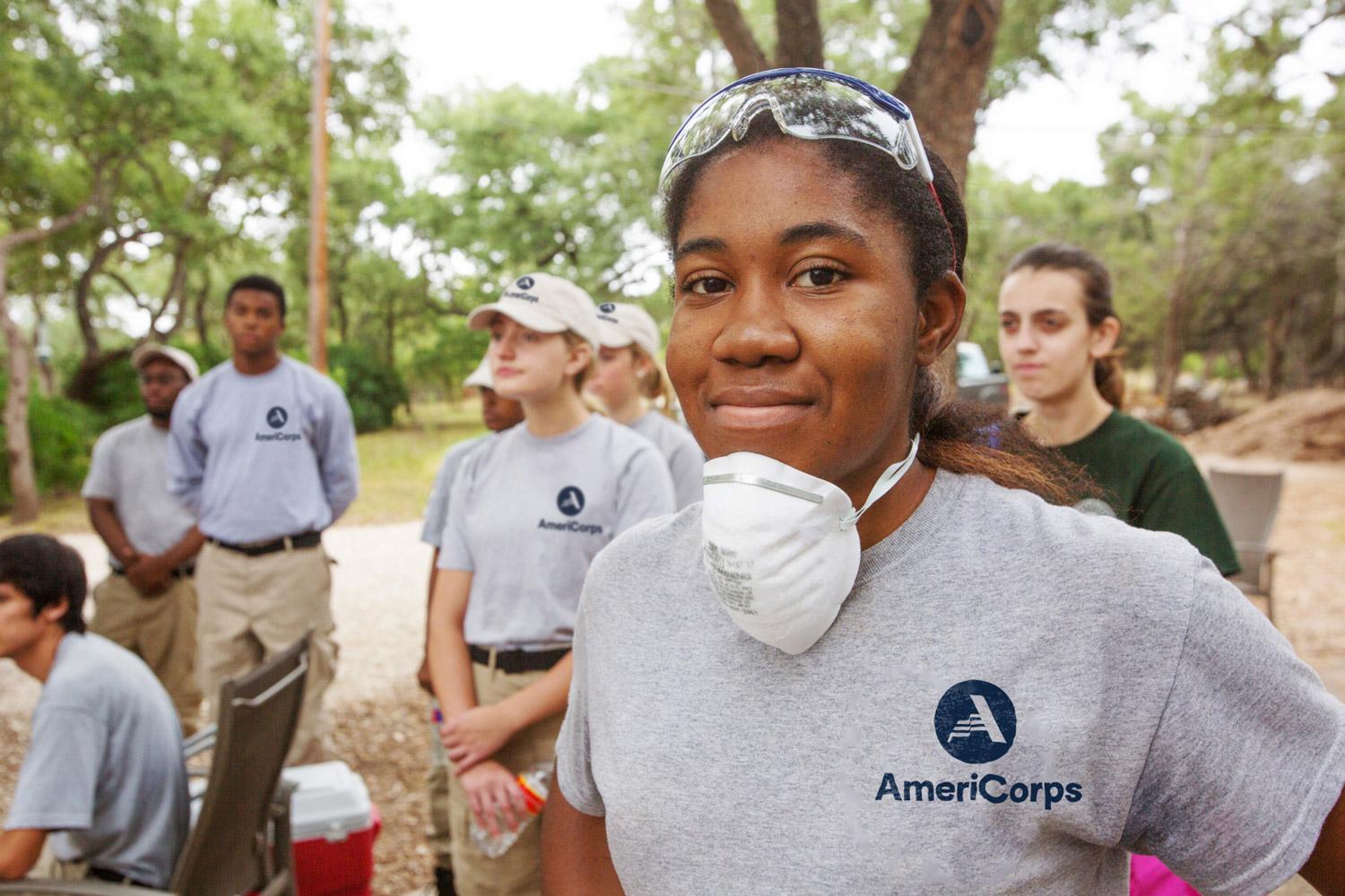 AmeriCorps member meeting with group.