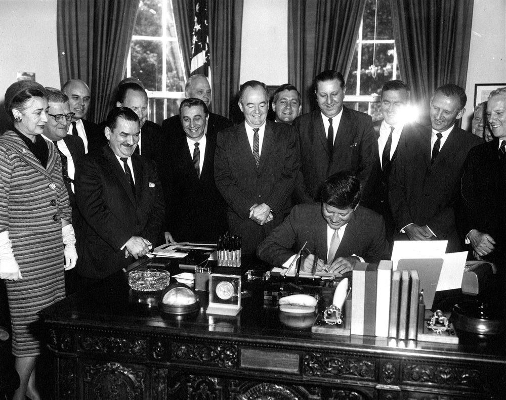 JFK signing Executive Order creating Peace Corps