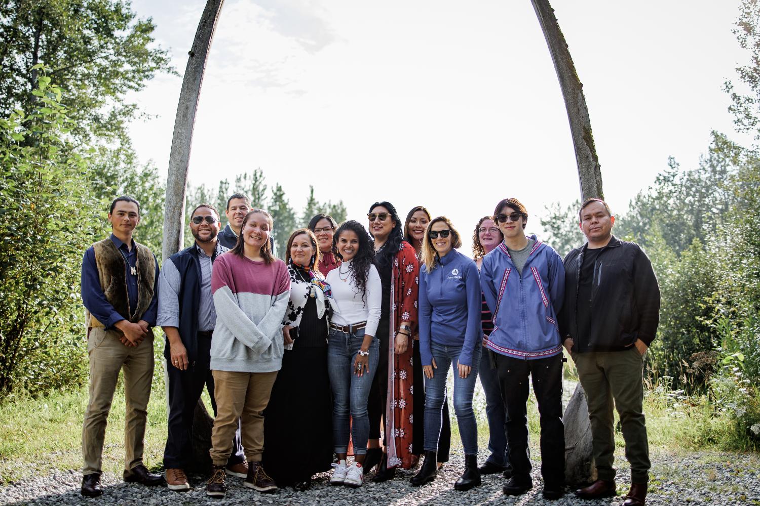 AmeriCorps CEO, AmeriCorps partners, and members posing in a group photo outside.