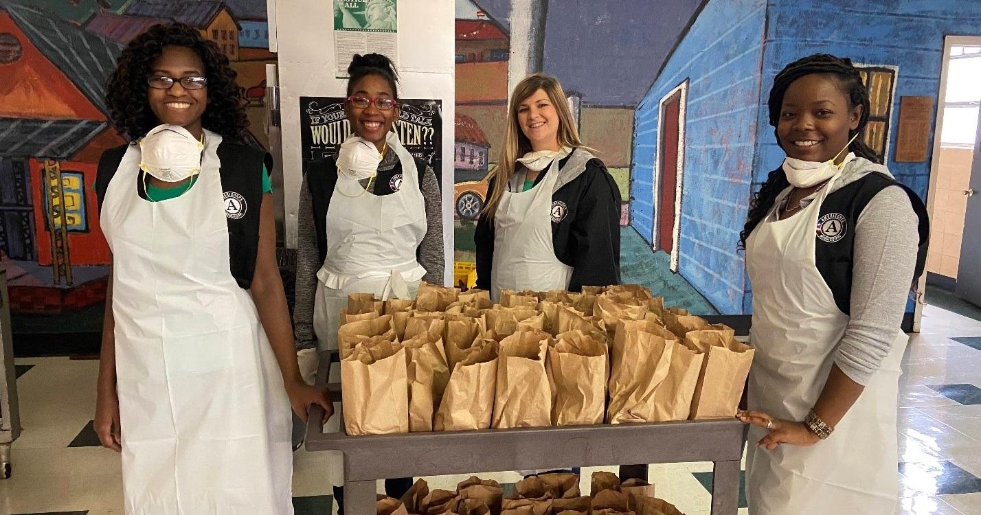 AmeriCorps members serving with the Grenada School District in Mississippi distribute summer meals during the COVID-19 pandemic.  