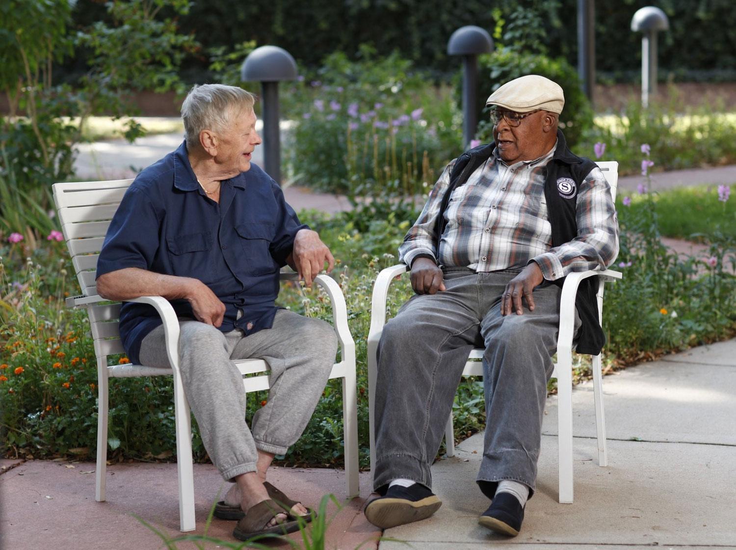 Senior Corps volunteer with fellow senior in a beautiful garden